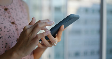 Woman use of mobile phone inside shopping mall