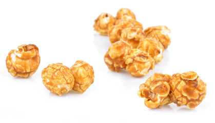 pieces of caramel popcorn on a white background