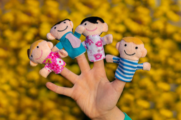 family finger dolls. child hand with finger puppets: son, daughter,mum, dad. Kid playing fingers...