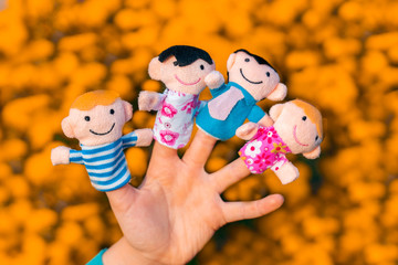 family finger dolls. child hand with finger puppets: son, daughter,mum, dad. Kid playing fingers...