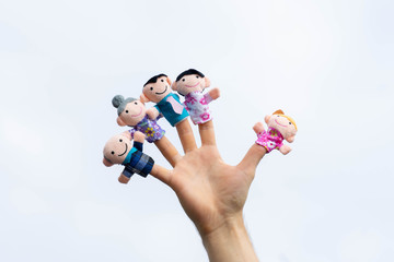 family finger puppet theater. child hand with finger puppets: son, daughter,mum, dad, granny,...