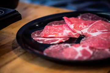 Shabu-shabu is a Japanese nabemono hotpot dish of thinly sliced meat and vegetables boiled in water. The term is onomatopoeic, derived from the sound emitted when the ingredients are stirred 