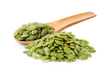Pumpkin seeds in wood spoon  isolated on a white background. full depth of field