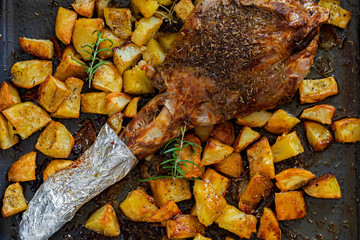Baked whole lamb leg with potatoes.