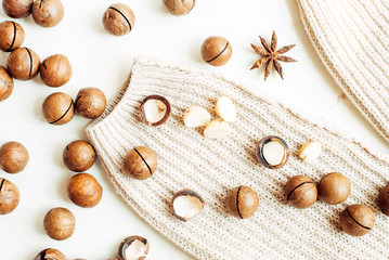 Macadamia nuts, star anise and warm sweater. Top view flat lay.