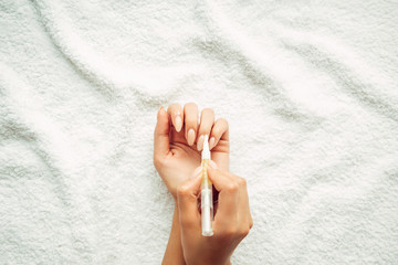 Application of cuticle oil. Moisturizing and Nail Care.