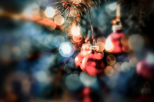 Christmas decorations in bright blue red gold  and white shiny and shimmering colors with Christmas lights with blurred background. 