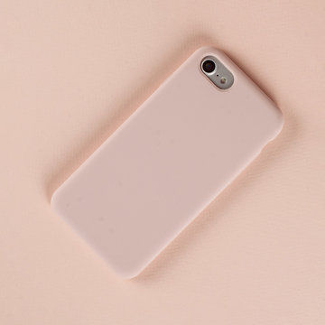 Cell Phone In Pink Case On Paper Background