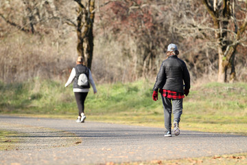 Women taking a walk in a park on a sunny day.