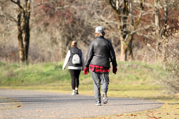 Women taking a walk in a park on a sunny day.