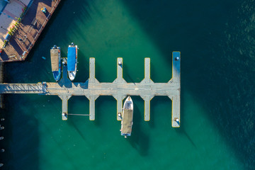 Aerial image from top view of speed boat and ferry stop at harbor deck at Jesselton Point, Kota...