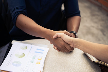 Businessmen shaking hands together happy. After the negotiations were successful