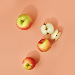 Apples on a colored background. Composition of apples and a piece of apple. Pattern of apples on colored background