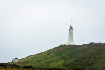 Fototapeta na wymiar Lighthouse in Reykjanes in Iceland during spring. Travel, lighthouse, icelandic concept.