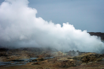 Smoke from the ground in geothermal area in the icelandic countryside. Power, geology, natural and nature concept.