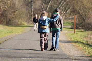 Mature couple taking a walk in a park on a sunny day.