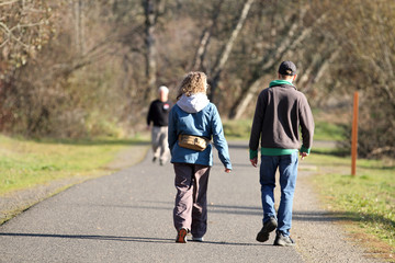 Mature couple taking a walk in a park on a sunny day.