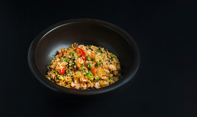Asian rice in the black bowl with copy space
