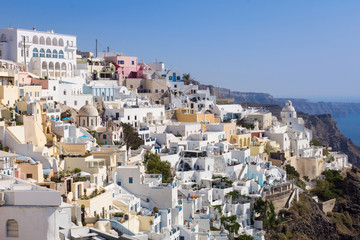 Fototapeta na wymiar Houses and view from the city of Oia in Greece. Summer, season, travel, hotel, luxury concepts.