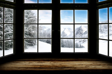 Table top with big window background and beautiful snowy winter landscape outside. Sunny winter day.