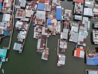 Top down aerial view of the local lifestyle traditional water village houses in a small village Beside sea at Kudat, Sabah, Borneo. 