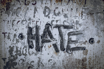 Hate written/painted on concrete wall. Texture, message, quote, statement concept.