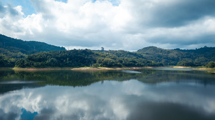 Mountain view with reflection on the lake, have cloudy sky in cinematic tone
