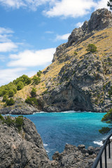 Fototapeta premium Beautiful famous bay of Sa Calobra on the island of Mallorca, Spain. Turquoise sea, rocks and pines. Travel to the Balearic Islands.
