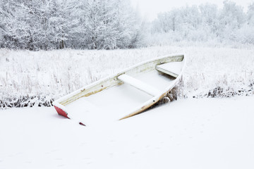 Rowing boat on the beach in winter landscape