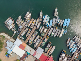 Fototapeta na wymiar Aerial image of local lifestyle fisherman boat parking at fresh seafood market jetty at Kudat, Sabah, Malaysia.