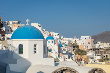 Church dome and buildings in Santorini, Greece. Travel, holiday, explore, backpacking, summer concept.