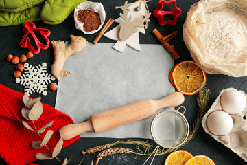 The process of making christmas cookies. Girl hands make the dough. Ingredients for baking a pie: flour, confectionery, dishes, kitchen utensils, spruce cookies figure on a dark background.Christmas g