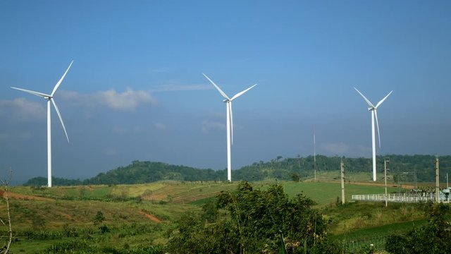 Wind turbine for electricity production in a field with blue sky