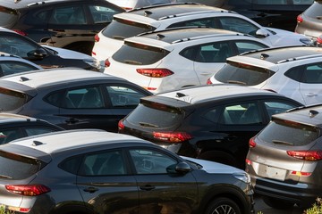 Lot of cars being transported to trade location
