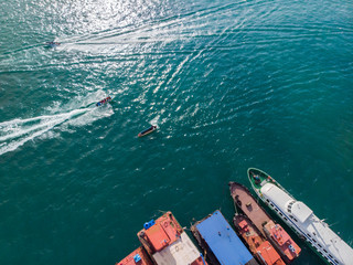 Aerial image of tourist speed boat on moving at clear blue sea at Waterfront Kota Kinabalu, Sabah,...