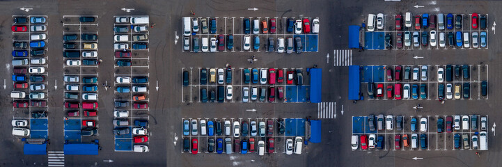 Banner aerial top view of parking with different cars. Many cars are parked in open parking near market. Parking places with vehicles.