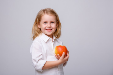 Fototapeta na wymiar baby girl with red Apple on white background