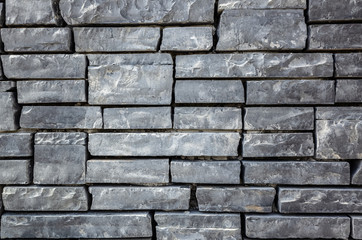 gray brick wall with rough texture