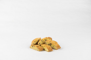 Fototapeta na wymiar Cantucci (double baked Italian biscuits, biscuits) with orange zest, almond nuts and dried cranberry. Flat layout, front view, place for text. White background.