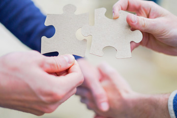 Cooperation puzzle partnership and handshake teamwork in business group team company.