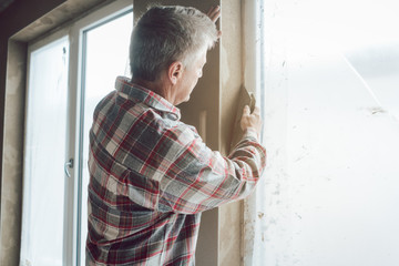 Plasterer working on a window opening