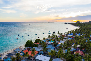 Aerial drone image of beautiful white sandy beach tropical island with turquoise sea water and...