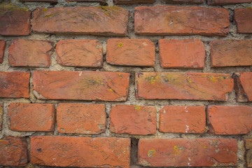 Red brick wall close-up. The laying of stones. Background texture for the site. Construction of the wall of quality materials.