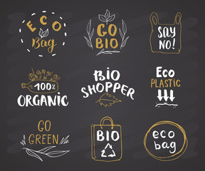 Fototapeta premium Eco and Bio Hand Drawn labels Set. Calligraphic Letterings with eco friendly sketch doodle elements. Vector illustration on chalkboard background