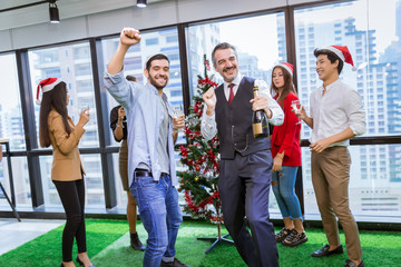 Group of happy young various people having happy new year party at the office.