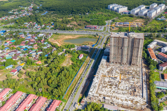 Aerial drone image of beautiful rural town with apartment on construction at Menggatal Town, Sabah, Malaysia