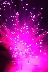 New Year and Christmas color illumination. The illusion of a salute explosion. The quirks of light fiber optic lamp.