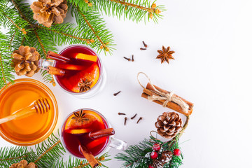 Mulled wine in glass mug with spices. Glasses of mulled wine with cinnamon, anise and fir tree...