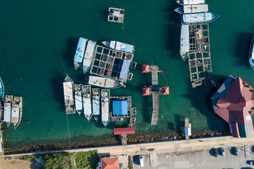 Aerial image of local lifestyle fisherman boat parking at fresh seafood market jetty at Kudat, Sabah, Malaysia.