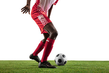 Professional african-american football or soccer player of red team in motion isolated on white studio background. Fit man in action, excitement, emotional moment. Concept of movement at gameplay.